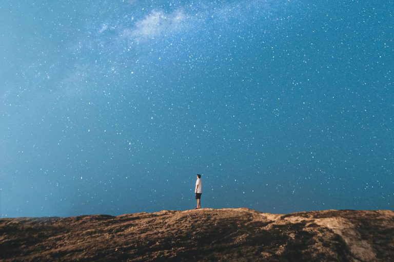 person looking at night horizon, signifying healing existential death anxiety